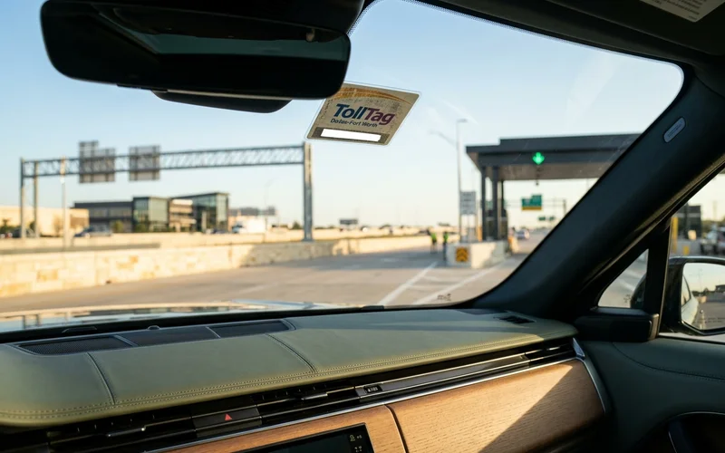 TollTag sticker on a windshield with a blurred tollway behind